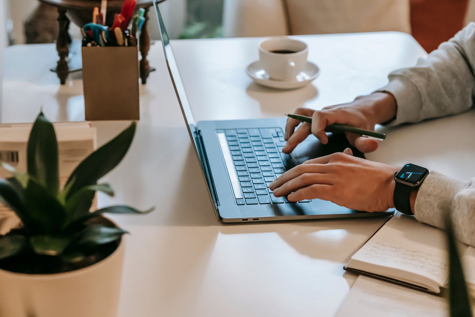 A desk setup with an open laptop displaying API documentation and a pricing calculator, next to a notebook with notes on business models and revenue projections. The scene is clean and pragmatic, reflecting the honest, no-nonsense approach to AI monetization.</illustrationAlt>