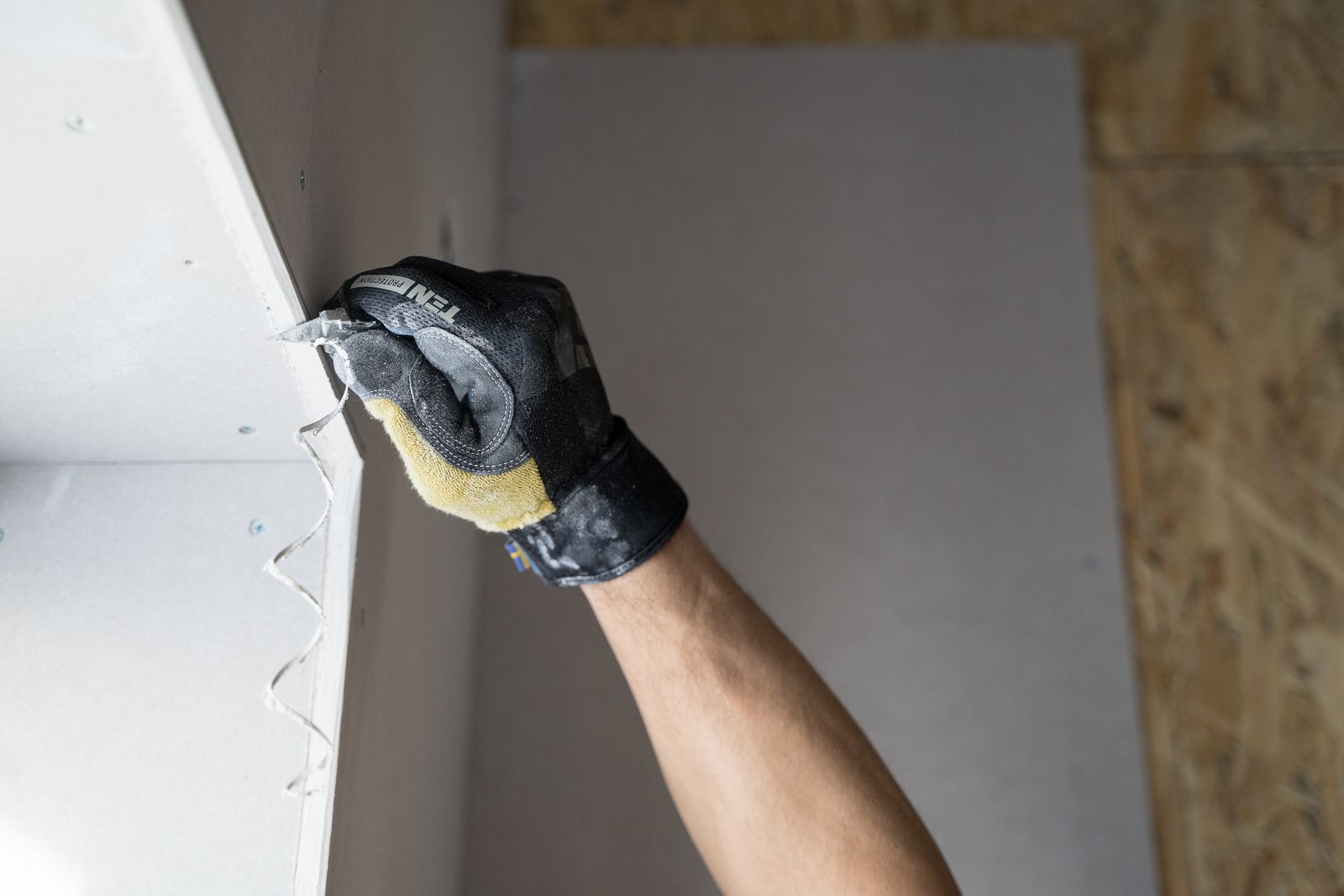 Diagram showing four drywall patches by hole size: a nail hole filled with spackle, a 1-inch hole covered with self-adhesive mesh tape and compound, a 4-inch hole patched using the California patch method with paper flange, and a large hole with wooden backing strips and a full drywall replacement patch.