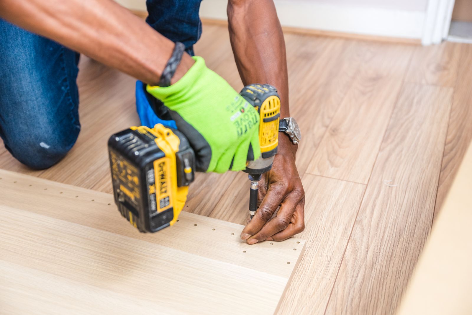 A cordless drill/driver with a 3-jaw chuck side by side with a compact impact driver with a 1/4-inch hex collet, on a workbench
