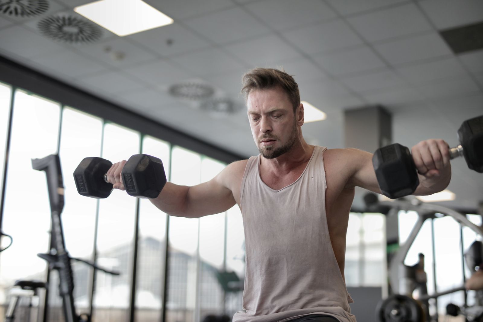 A split-panel diagram showing three stages of the dumbbell circuit: (Left panel) a man performing a goblet squat with a dumbbell held at chest height, knees bent 90 degrees, weight balanced. (Center panel) a man lying on a flat surface performing a dumbbell bench press, elbows bent and dumbbells at chest level. (Right panel) a man in a hinge position performing a dumbbell row with both arms, dumbbells at hip height. All figures demonstrate neutral spine alignment and full range of motion.</illustrationAlt>